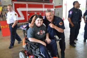 Dylan Hall, left, poses for a photo with Port Arthur Fire Capt. Perry Manuel during a kick-off event for Port Arthur Professional Fire Fighters Association Local 397 and the Muscular Dystrophy Association’s Annual Fill the Boot Campaign at Fire Station 1 on Thursday. Mary Meaux/The News 