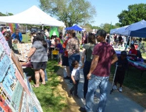 Crowds move along the sidewalks during Art in the Park in Doorknobs Park in Nederland on Saturday. Mary Meaux/The News