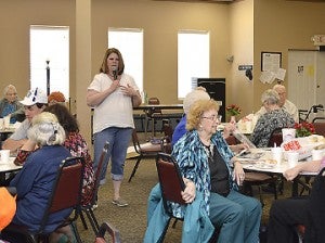 Sharon Lemoine, director of the Port Neches Senior Citizens Center, makes announcements prior to lunchtime. Mary Meaux/The News 
