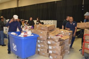 Volunteers unload frozen turkeys during the Seventh Annual Thanksgiving Basket Giveaway sponsored by Everlasting Changes at the Robert A. “Bob” Bowers Civic Center on Saturday. Mary Meaux/The News