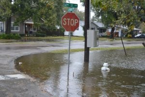 The corner of 32nd Street and 4th Avenue in Port Arthur starts to become waterlogged due to heavy rains on Saturday. (Lorenzo Salinas/The News)