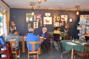 Friends and family of the sister owners sit and talk at the ribbon cutting Thursday at Gather: Paleo Cafe & Market in Port Neches. (Lorenzo Salinas/The News)