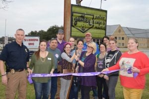 Friends, family, Chamber members and Gather workers come together to ceremonially cut the ribbon at Gather: Paleo Cafe & Market in Port Neches. (Lorenzo Salinas/The News)