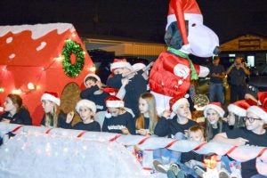 Children celebrate the holidays with cheer and with Snoopy from Peanuts. (Lorenzo Salinas/The News)