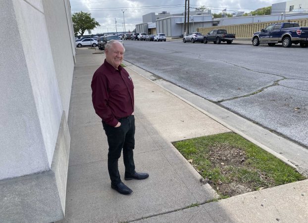 Museum of the Gulf Coast Director Tom Neal stands where dead trees have been removed and new crepe myrtles will be planted next week. (Monique Batson/The News)